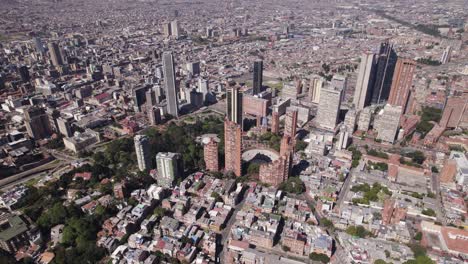 High-angle-drone-shot-circling-the-Bogota-city-skyline,-sunny-day-in-Colombia