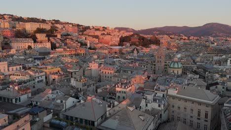 Golden-hour-over-Genoa's-historic-buildings,-warm-sunlight-bathing-the-cityscape,-rooftops