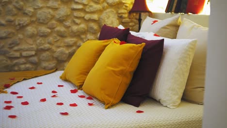 Romantic-bed-setup-with-rose-petals-and-pillows