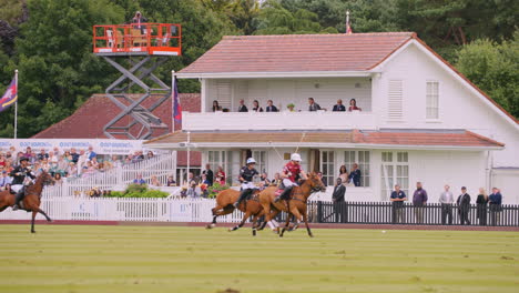 Queen-Elizabeth-II-watches-polo-players-chase-after-the-ball-at-full-gallop