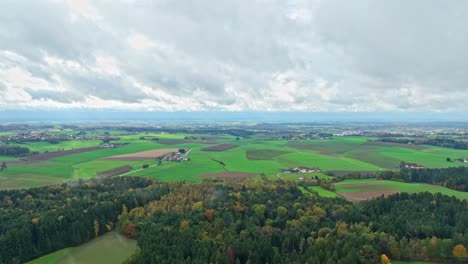 Autumn-Forest-And-Fields-Against-Cloudy-Sky---Aerial-Drone-Shot