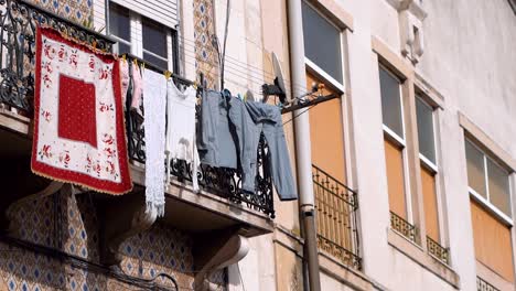 clothes-hanging-on-clotheslines-outside-the-balcony-at-residential-building,-City