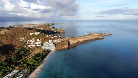 Houses-on-peninsula-on-tropical-island,-Grenada-aerial