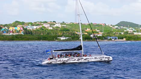 Aerial-tracking-follows-Catamaran-cruising-along-coastline-of-Otrobanda-Willemstad-Curacao