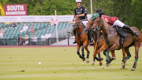 Two-polo-players-ride-at-full-gallop-fighting-to-get-the-ball