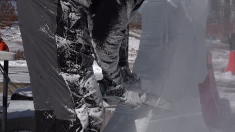 Ice-sculptor-crafting-ice-sculptures-with-chainsaw
