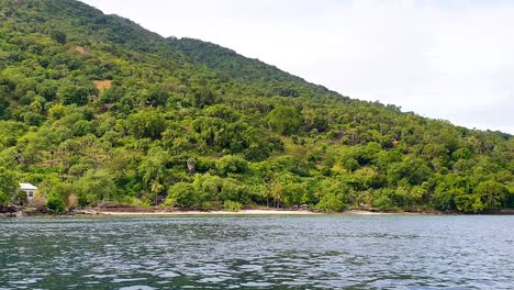 Rainforest-tree-covered-remote-tropical-island-and-ocean-views-on-Alor-Island-in-Lesser-Sunda-Islands-of-East-Nusa-Tenggara,-Indonesia