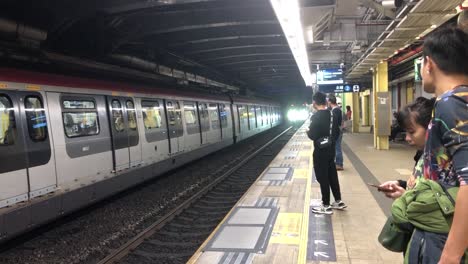 Ein-Paar-Wartet-Am-MTR-Bahnhof-In-Tai-Po-In-Den-Neuen-Provinzen,-Hongkong,-Darauf,-In-Den-Zug-Einzusteigen