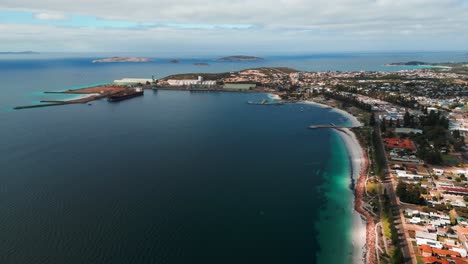 aerial-view-of-Esperance-City-Esplanade-and-the-harbour-in-the-background-with-a-tanker-getting-refueled-on-an-overcast-day,-western-australia