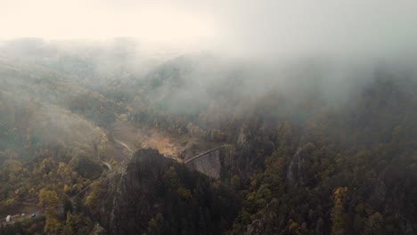 azrial-view-over-gouffre-d'enfer-dam-through-fog-and-clouds-near-Saint-Etienne,-france
