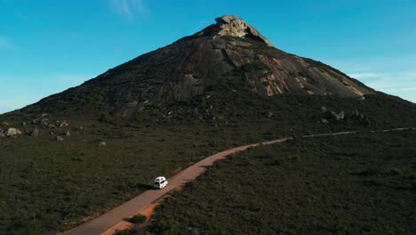 aerial-of-a-van-driving-to-frenchman-peak-in-Cape-Legrand-National-Park-on-a-sunny-morning-near-Esperane,-Western-Australia