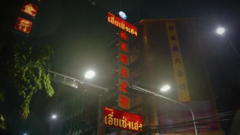 Bangkok-vertical-illuminated-sign-on-a-dark-rainy-night