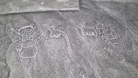 Aerial-view-of-the-mysterious-humanoid-creatures-in-Nazca-desert,-Peru