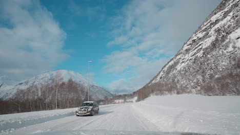 POV-driving-footage-on-snowy-mountain-roads-during-winter