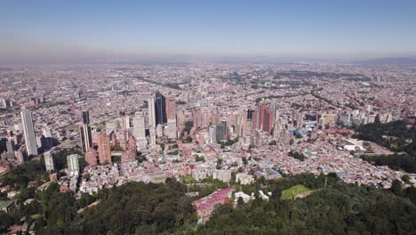 Aerial-view-approaching-the-downtown-of-Bogota-from-Monserrate,-in-sunny-Colombia