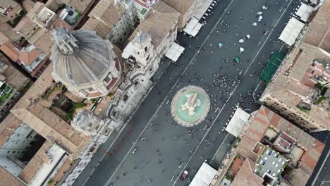 Aerial-shot-of-a-public-esplanade-full-of-people-and-buildings-in-the-city-of-Rome