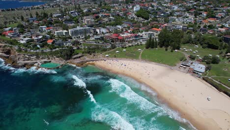 Aerial-View-Over-Bronte-Beach-With-Tourists-In-Sydney,-New-South-Wales,-Australia---Drone-Shot