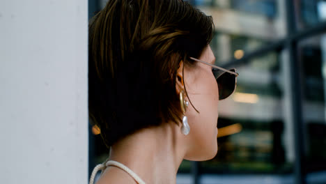 Close-up-view-of-elegant-woman-in-sunglases-and-earrings