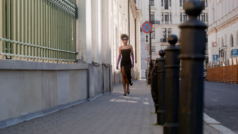 Young-elegant-african-woman-walking-down-the-street