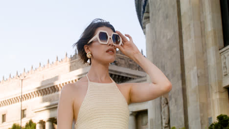 Lower-view-of-elegant-woman-putting-the-sunglases-on