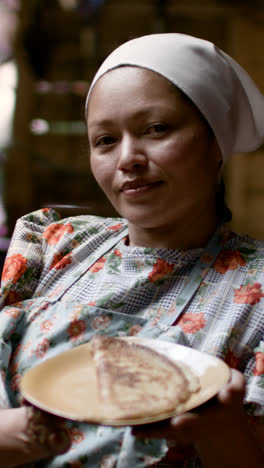 Woman-showing-tortilla-in-a-plate