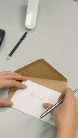 Woman-putting-paper-inside-of-an-envelope