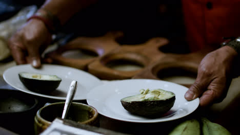 Man-putting-avocados-on-plates
