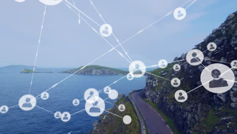 Animation-of-network-of-profile-icons-against-aerial-view-of-a-road-and-sea