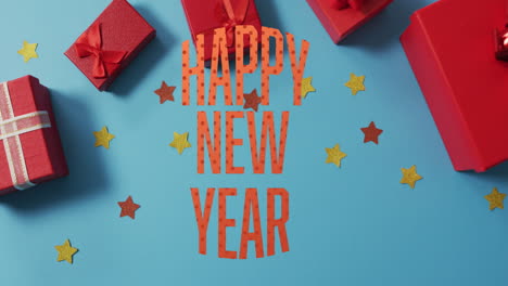 Animation-of-happy-new-year-text-with-stars-and-gift-boxes-against-blue-background