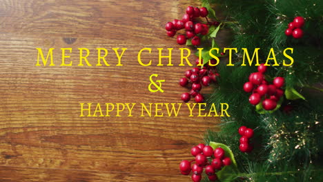 Animation-of-merry-christmas-and-happy-new-year-text-with-berry-and-leaves-on-table