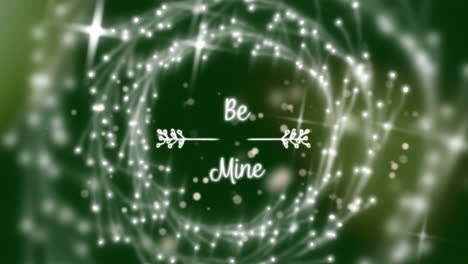 Animation-of-be-mine-text-with-illuminating-decoration-on-green-background