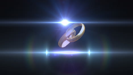 Animation-of-two-interlocked-gold-wedding-rings-and-white-beams-on-light-on-black-background