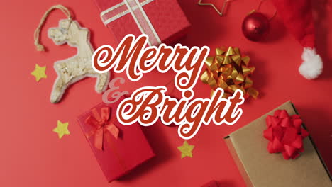 Animation-of-merry-and-bright-text,-gift-boxes,-bauble,-decoration-materials-on-red-background