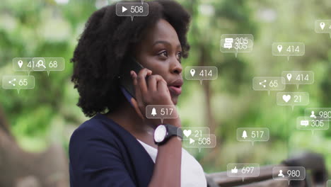 Animation-of-changing-numbers-in-notification-bars,-african-american-woman-talking-on-cellphone