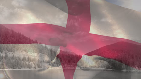 Animation-of-flag-of-england-over-scenic-view-of-lake,-mountain-against-cloudy-sky