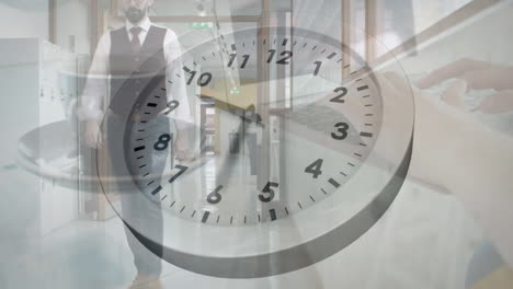 Animation-of-ticking-clock-against-caucasian-businessman-walking-in-office-corridor
