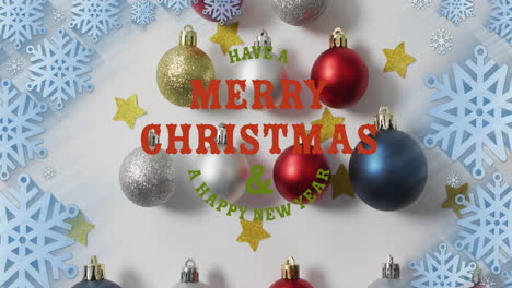 Animation-Eines-Textes-„Frohe-Weihnachten-Und-Ein-Gutes-Neues-Jahr“-über-Stern,-Kugeln-Und-Schneeflocken