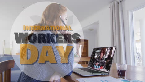 Animation-of-international-workers-day-text-over-caucasian-businesswoman-discussing-over-video-call