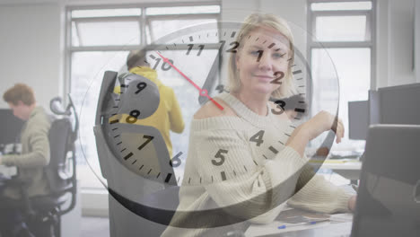Animation-of-ticking-clock-against-portrait-of-caucasian-woman-smiling-while-working-at-office