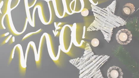 Animation-illuminated-merry-christmas-and-happy-new-year-text-over-christmas-decorations-on-table
