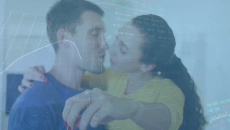 Animation-of-graphs,-trading-board-over-caucasian-woman-holding-key-and-kissing-man-at-home