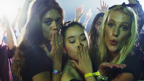 Group-of-women-giving-flying-kiss-at-a-concert-4k