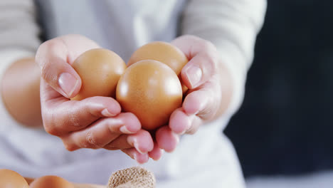 Woman-holding-brown-eggs-4k