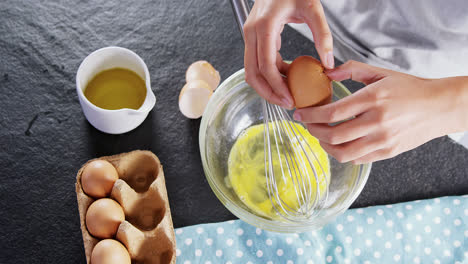Woman-breaking-eggs-into-a-bowl-4k
