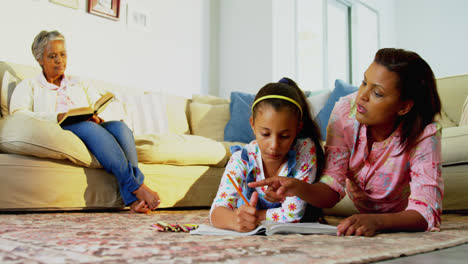 Mother-assisting-her-daughter-with-drawing-in-living-room-4k