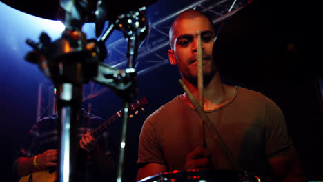 Drummer-playing-on-drum-set-on-stage-4k