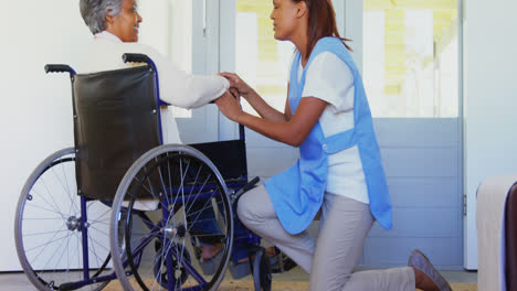 Female-doctor-interacting-with-senior-woman-on-wheelchair-4k