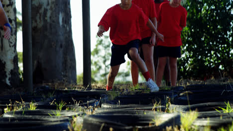 Kids-running-over-tyres-during-obstacle-course-training
