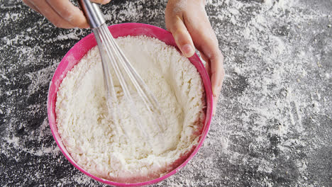 Woman-whisking-flour-in-bowl-4k