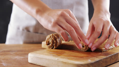 Woman-rolling-dough-on-chopping-board-4k